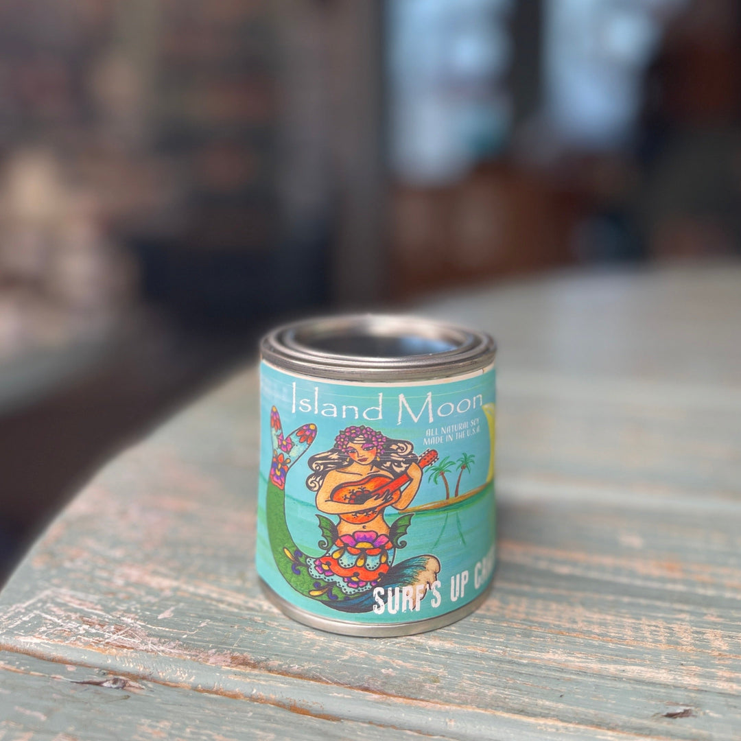 Surf's Up Candle Island Moon scent in a paint can style pint tin on wooden surface