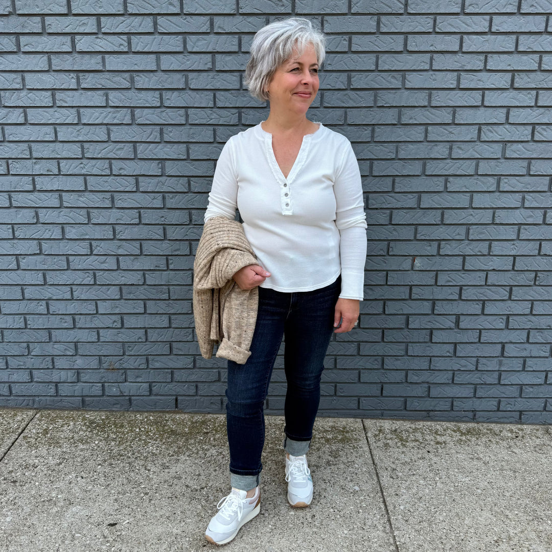 Women's long sleeve V-neck top with button trim and hi-lo hem – model Becky wears a medium, fits true to size.

