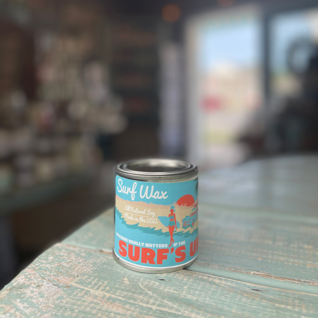 Surfs Up Candle Paint Can Pint candle in Surf Wax scent with retro beach label on weathered teal surface