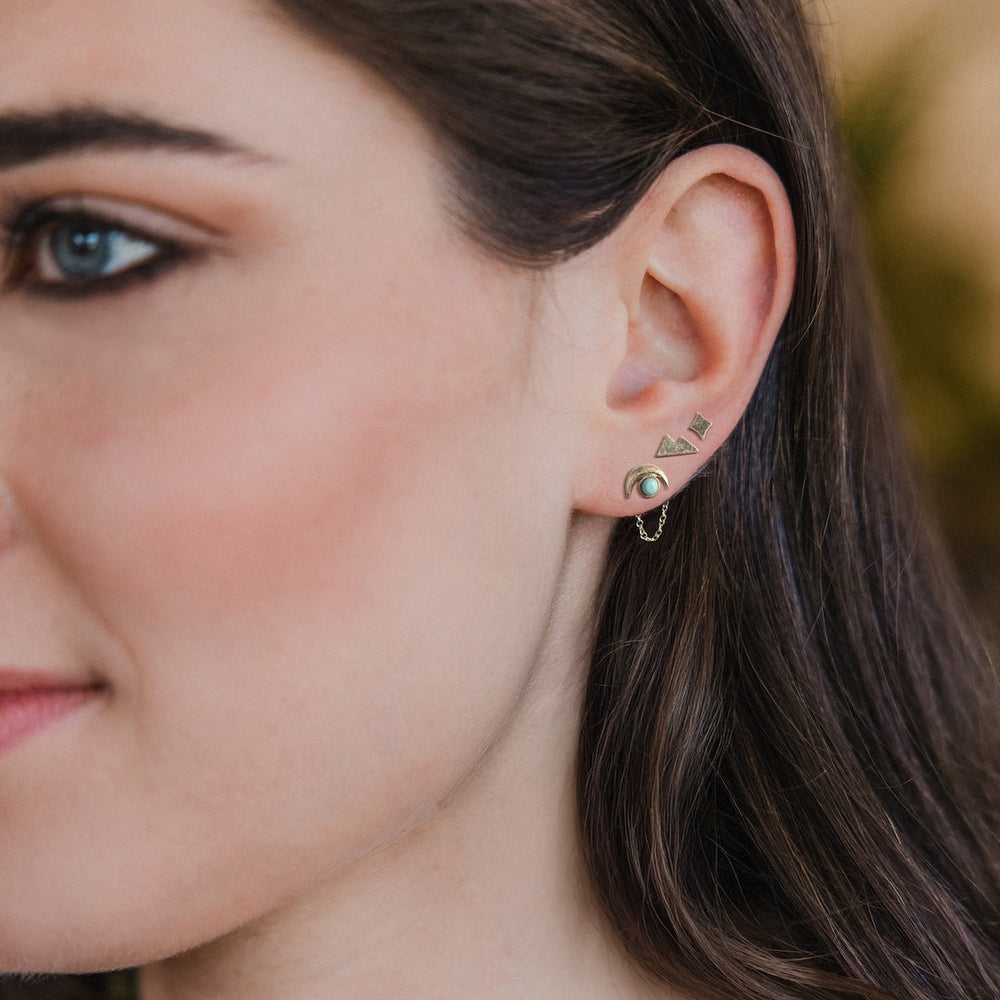 Scout Stud Trio Jacket Set earrings with gold geometric studs and turquoise stones worn on ear