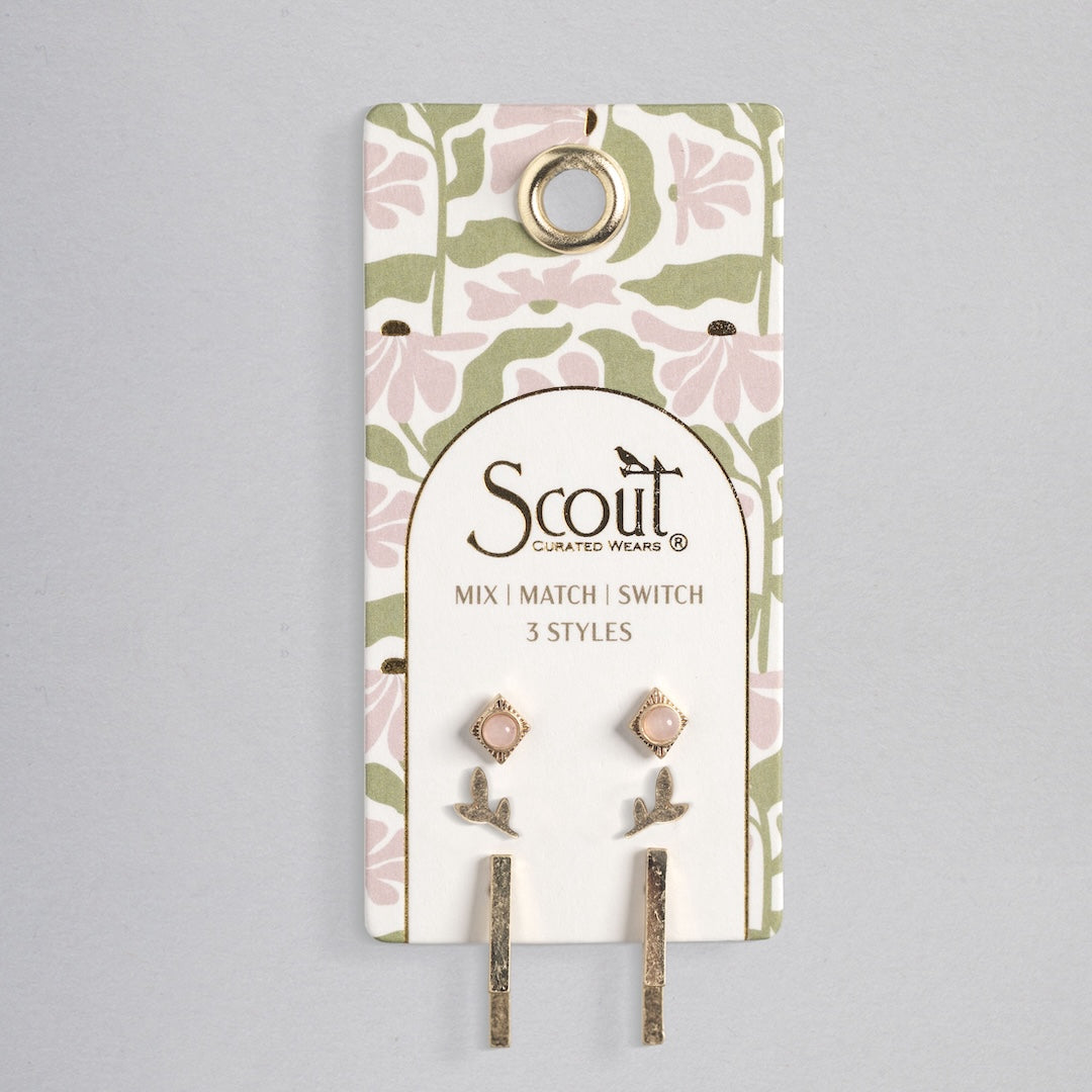 Scout stud trio earring set with pink stones, leaf designs, and gold bars on floral card