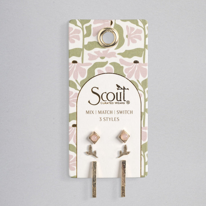 Scout stud trio earring set with pink stones, leaf designs, and gold bars on floral card