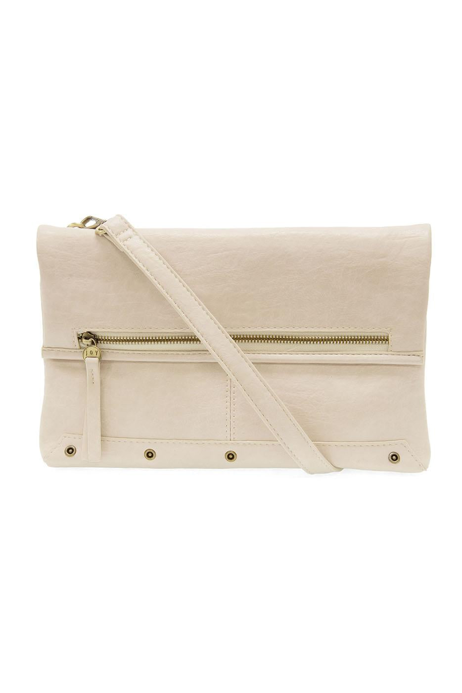 Cream colored fold over crossbody bag with gold zipper and adjustable strap