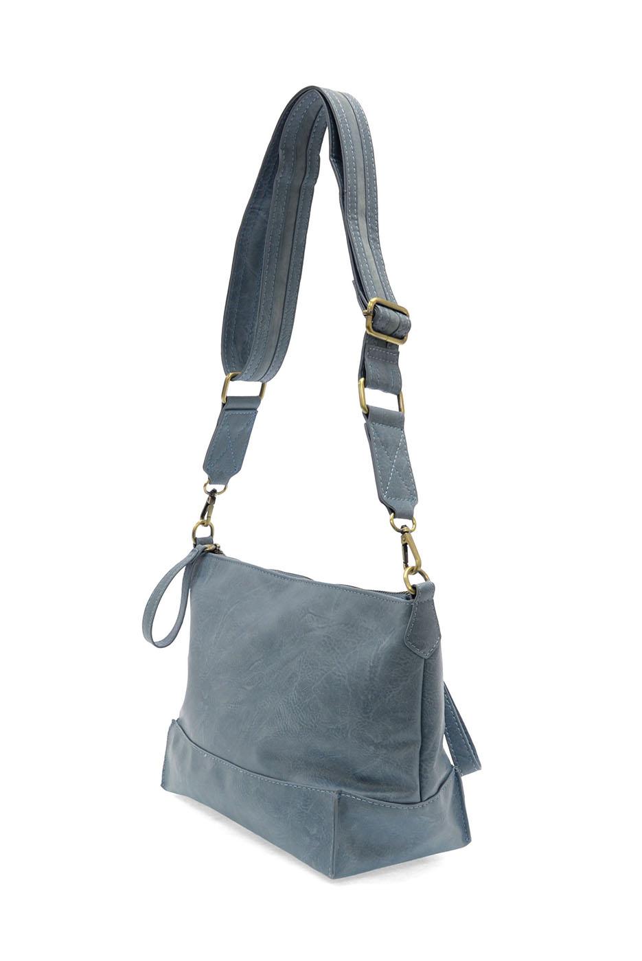 Chambray blue crossbody bag with adjustable strap and seamed design details