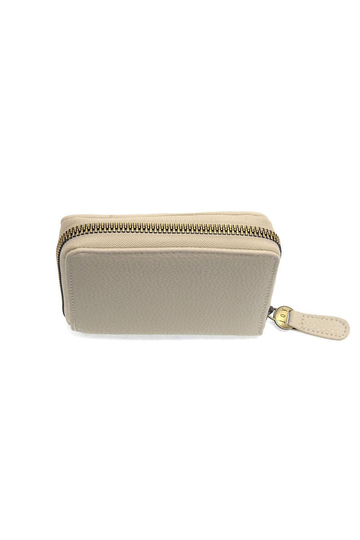 Light beige zip-around wallet with gold zipper and pull tab on white background