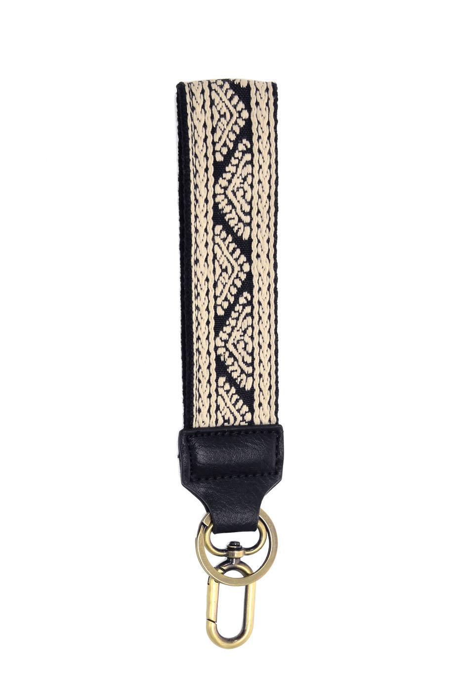 Black and beige geometric woven wristlet keychain with gold hardware and leather tab