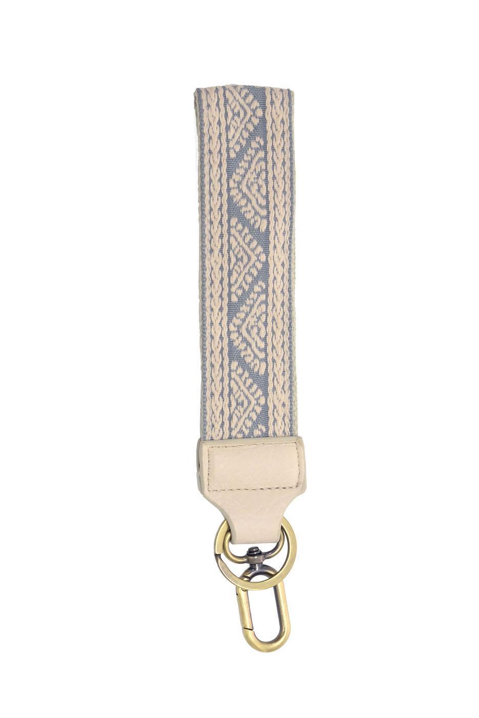 Cream and gray geometric woven wristlet keychain with gold clasp and leather tab