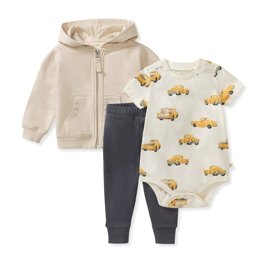 Burt's Bees Baby 3-piece set with beige hoodie, navy pants, and truck-print onesie