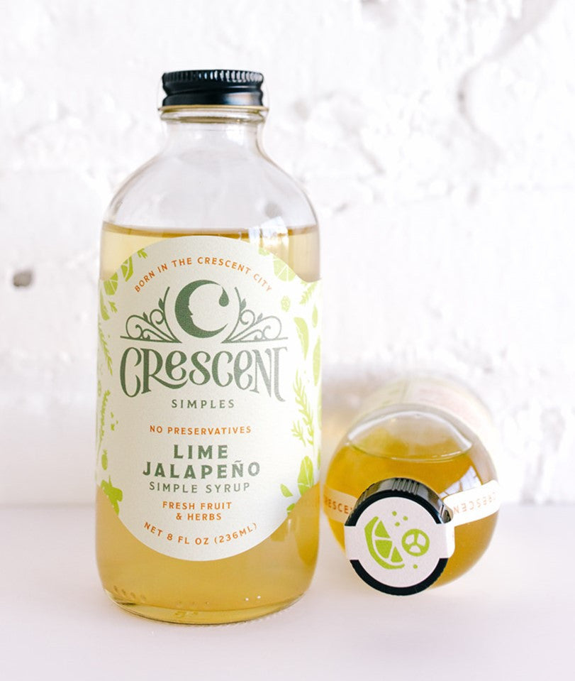 Crescent Simples Lime Jalapeno Simple Syrup bottle with yellow-green liquid and black cap
