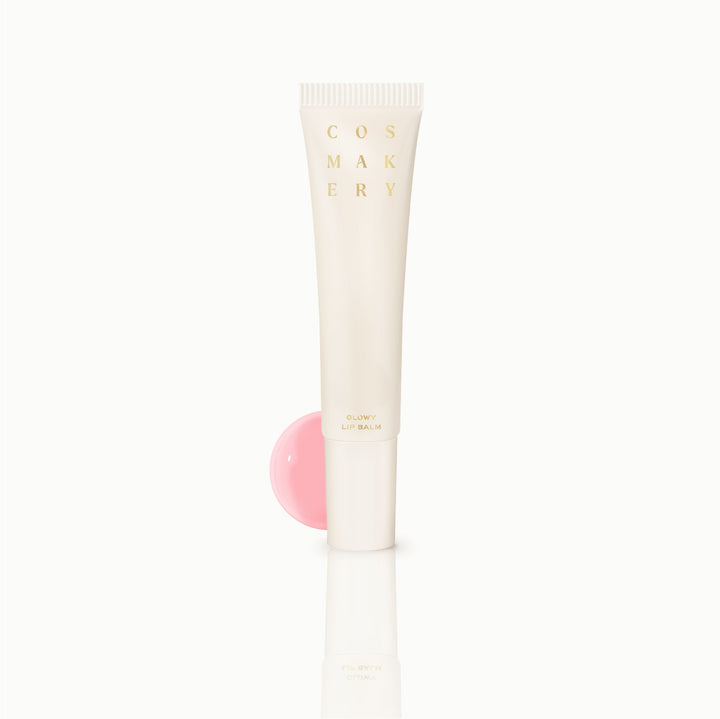 Cosmakery Glowy Lip Balm in clear tube with pink tinted balm on white background