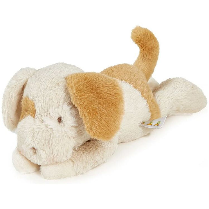 Plush puppy stuffed animal in cream and golden brown lying on side