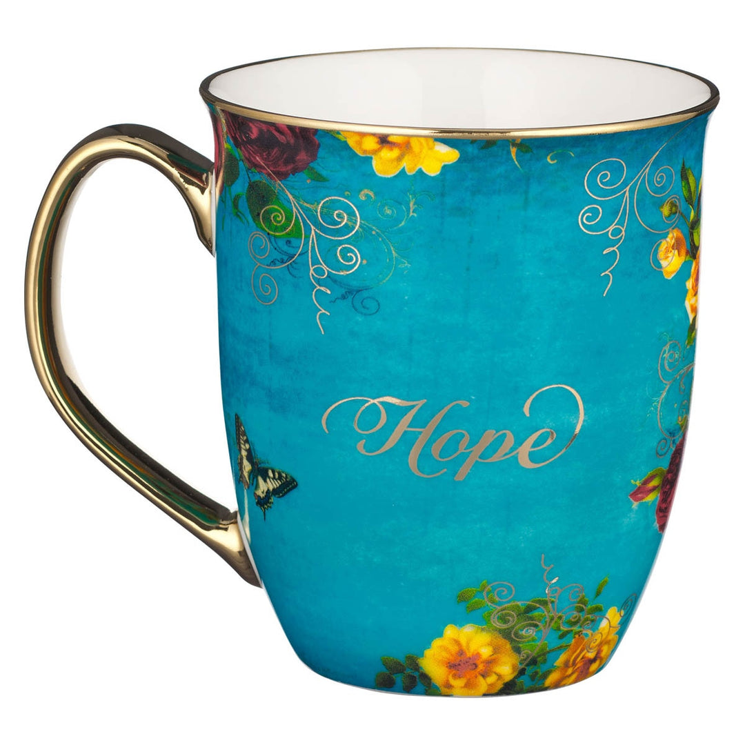 Teal ceramic mug with Hope text, colorful flowers, butterfly, and gold handle