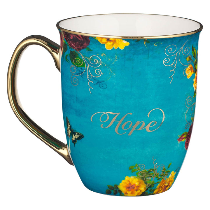 Teal ceramic mug with Hope text, colorful flowers, butterfly, and gold handle