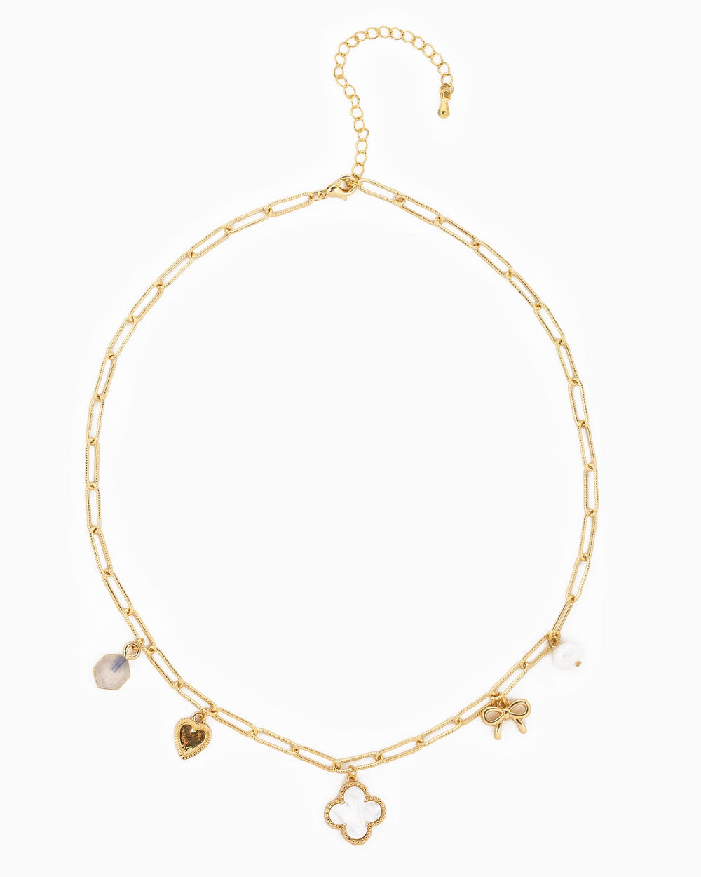 Gold paperclip chain necklace with clover, heart, bow, and crystal charms on white background.