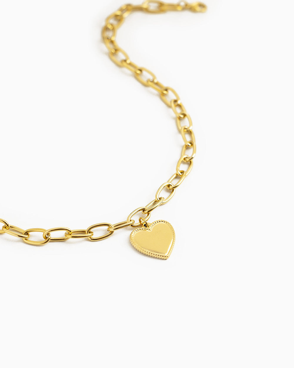 Gold stainless steel chunky oval link chain necklace with polished heart pendant charm.