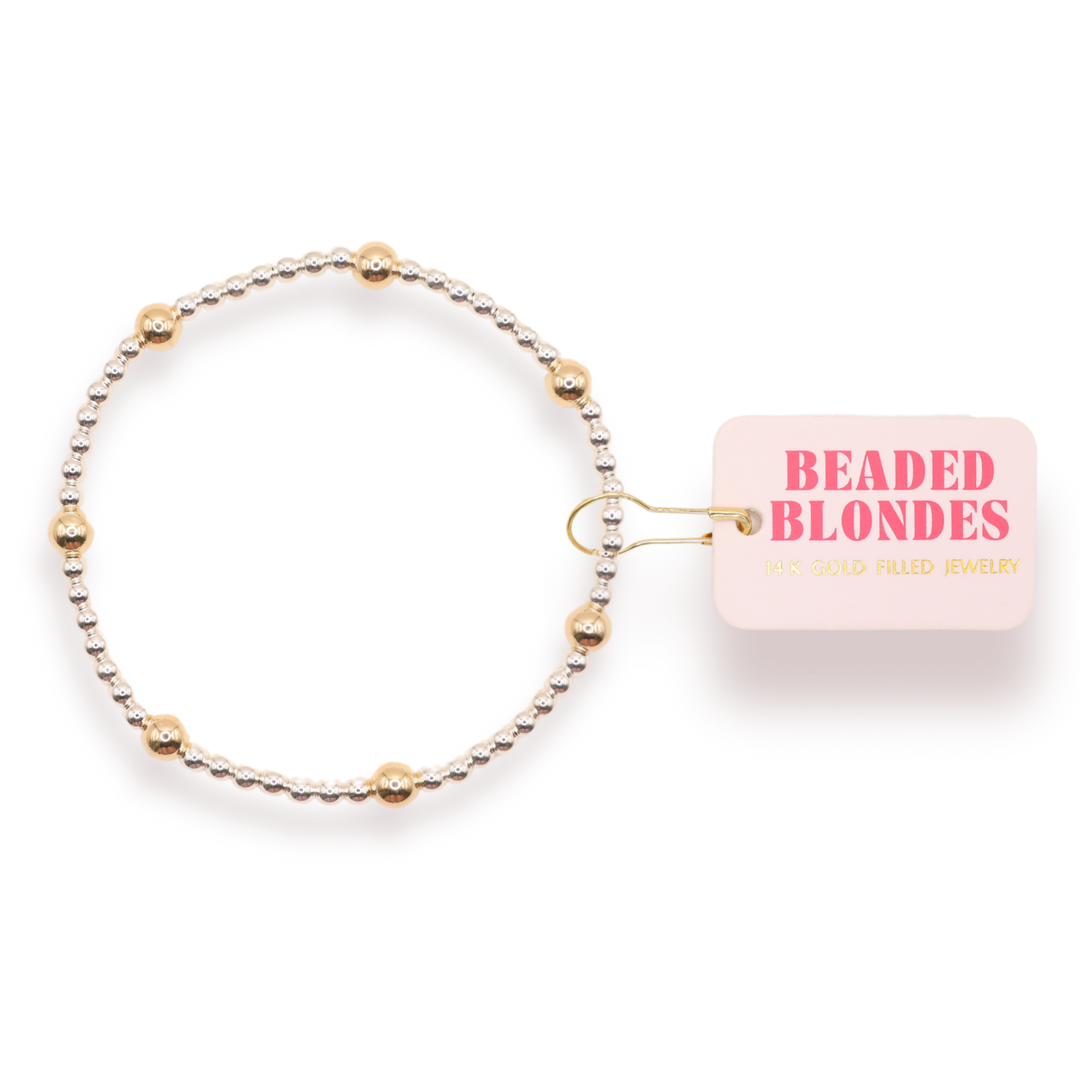 Beaded Blondes Olive Bracelet featuring silver beads with gold accent beads on elastic band