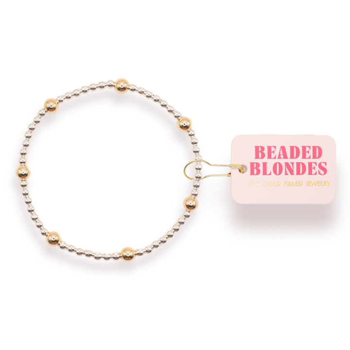 Beaded Blondes Olive Bracelet featuring silver beads with gold accent beads on elastic band