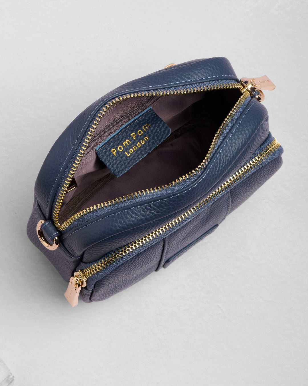 Pom Pom London Original Mini Bag in navy blue leather with gold zippers open