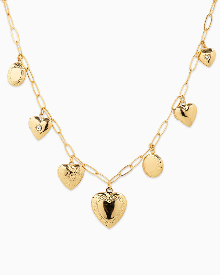 Sessori Seven Heart Locket Charm Necklace in gold with mixed heart and oval locket pendants