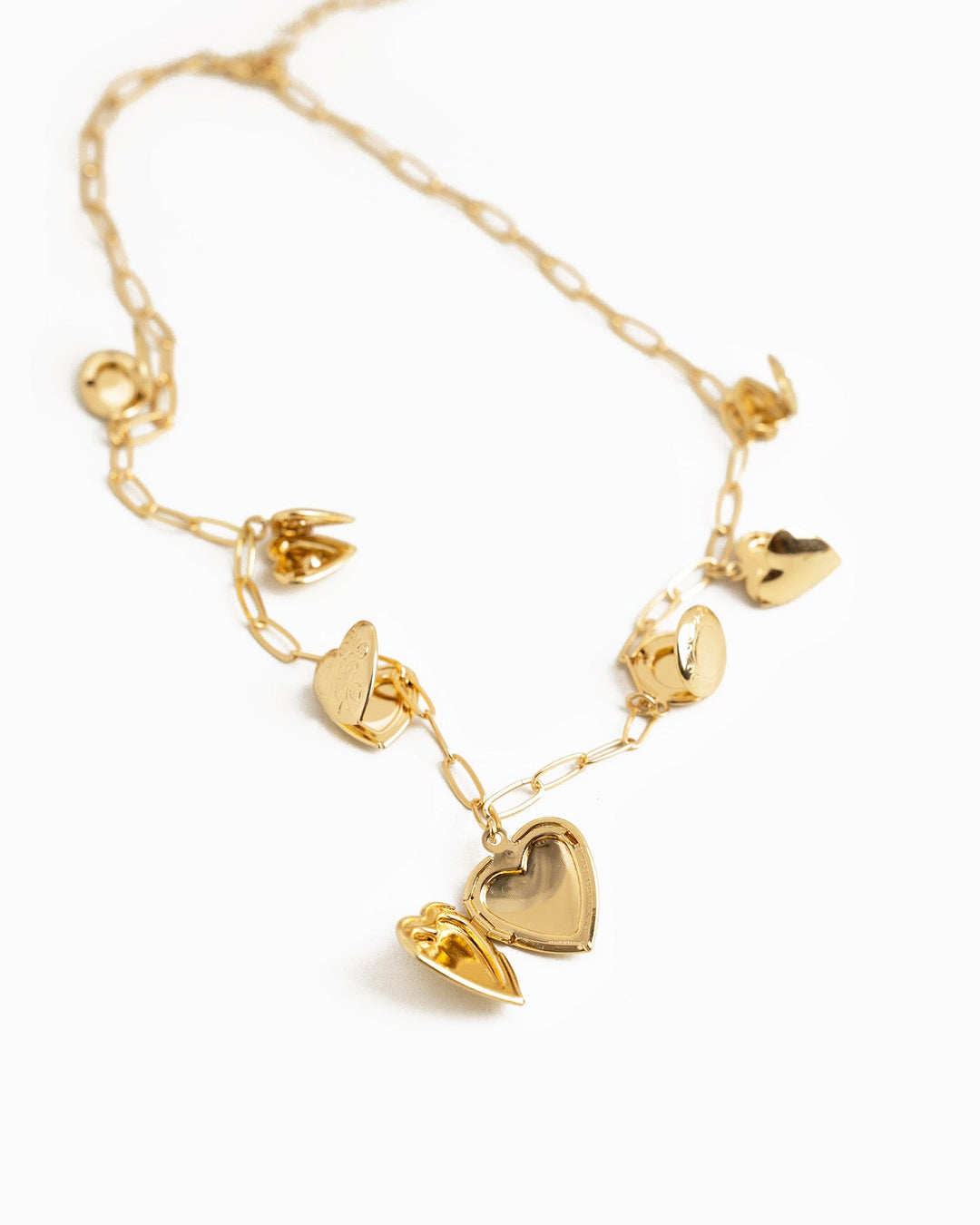 Sessori Seven Heart Locket Charm Necklace in gold with multiple opening heart locket charms on a delicate chain.