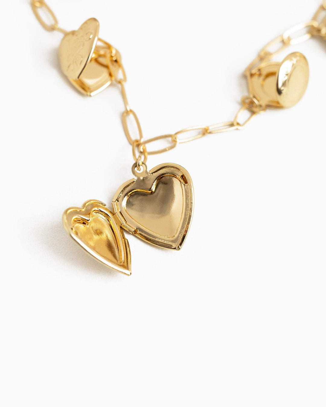 Gold seven heart locket charm necklace with open heart locket pendant on paperclip chain