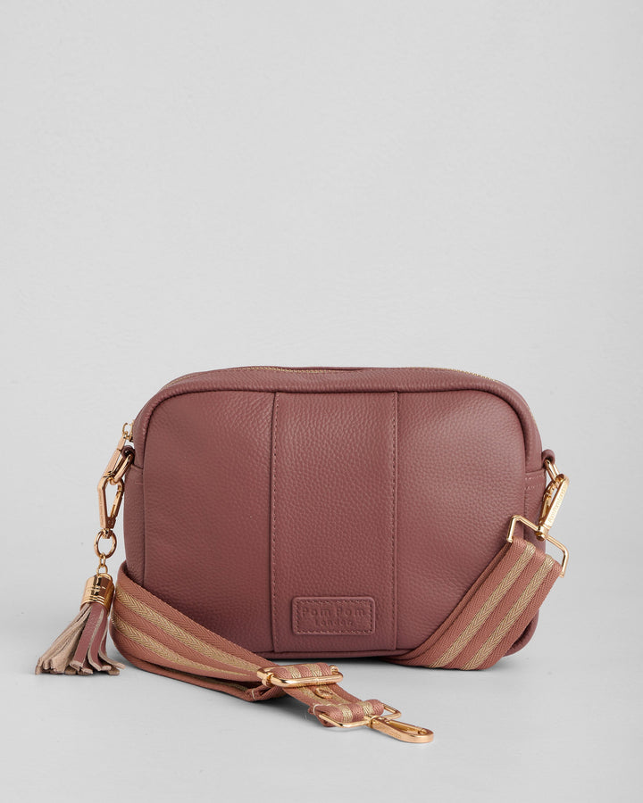 Pom Pom London dusty pink leather crossbody bag with striped strap and tassel detail