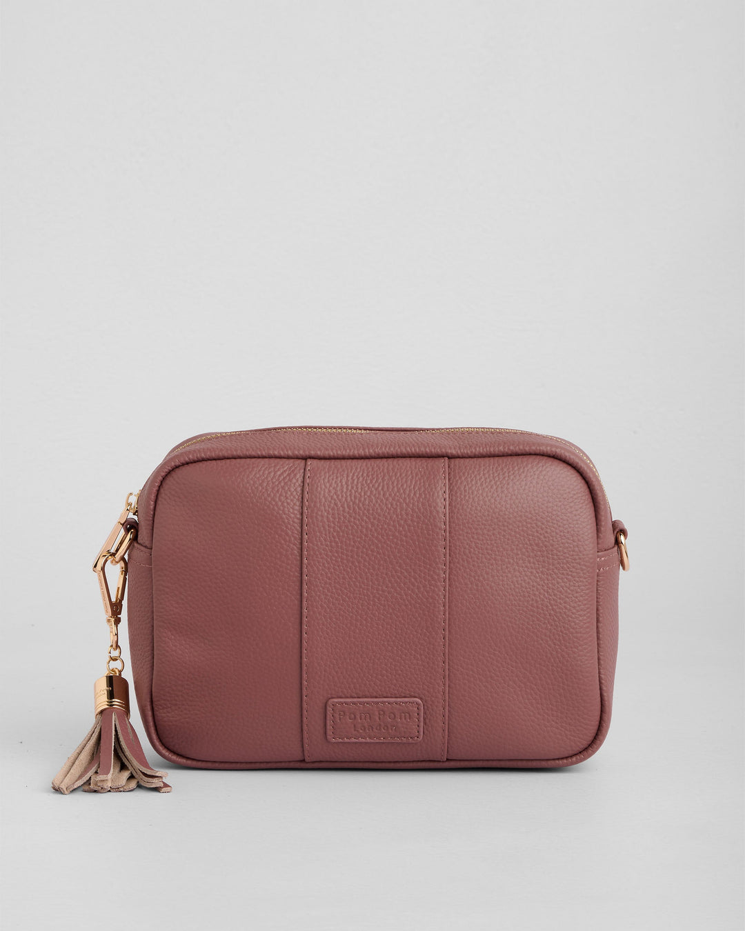 Dusty rose leather crossbody bag with gold hardware and tassel detail