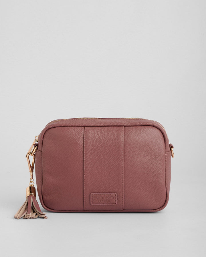 Dusty rose leather crossbody bag with gold hardware and tassel detail