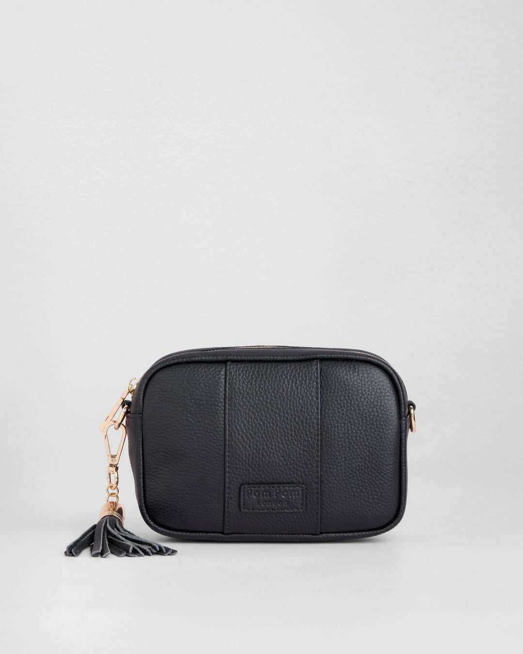 Black leather Pom Pom London City Mini crossbody bag with tassel detail