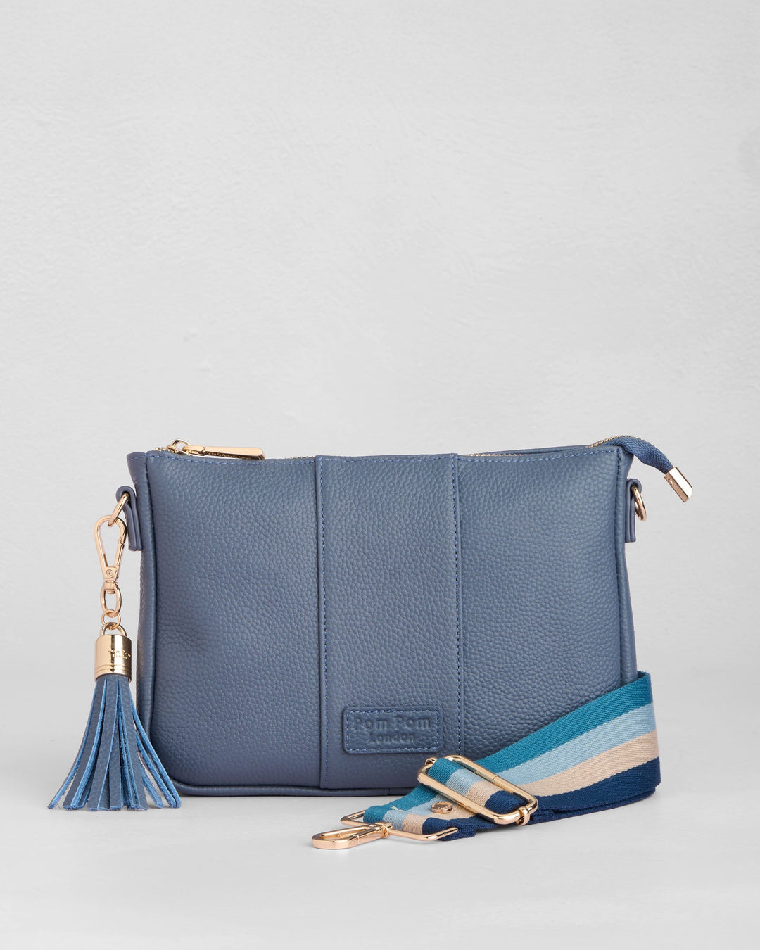 Pom Pom London City Slim Bag in slate blue leather with tassel and striped strap