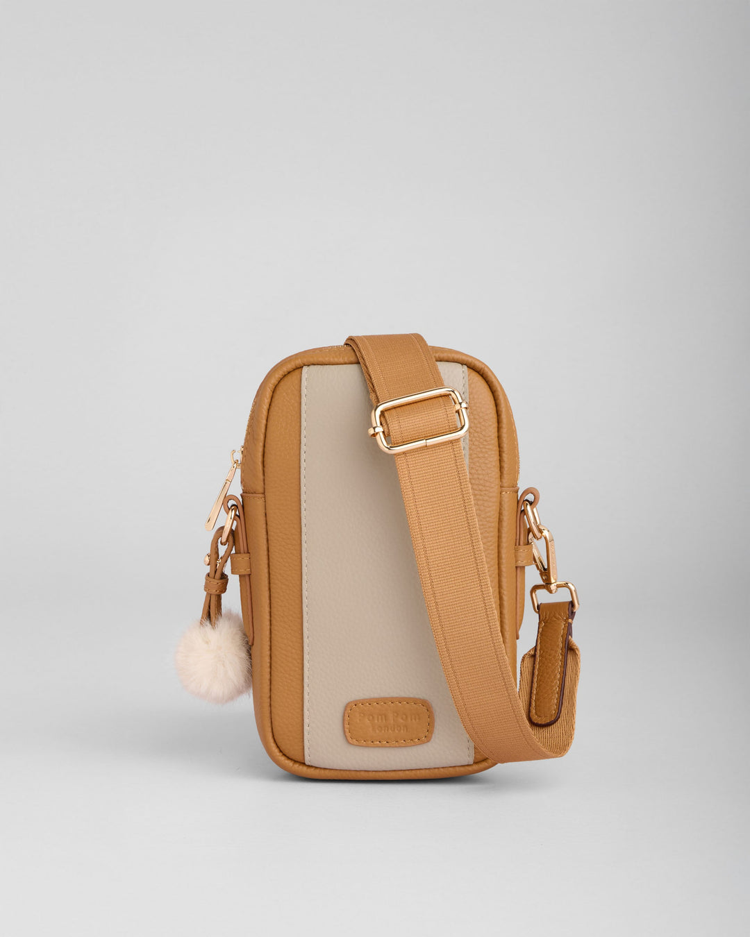Pom Pom London Eaton crossbody phone bag in maple brown and stone beige with pom pom charm