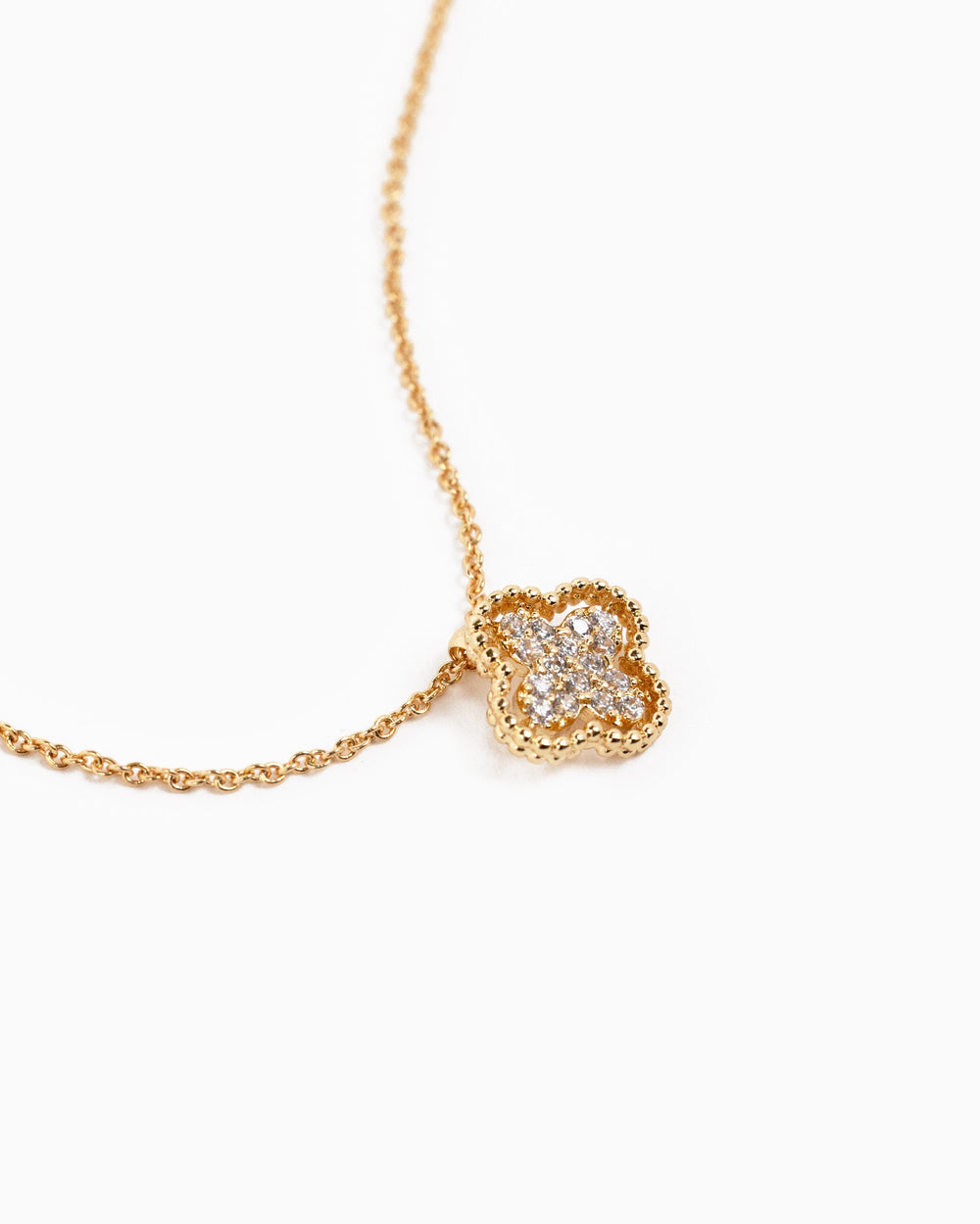 Gold open frame four-leaf clover necklace with pavé CZ diamond stones on delicate chain