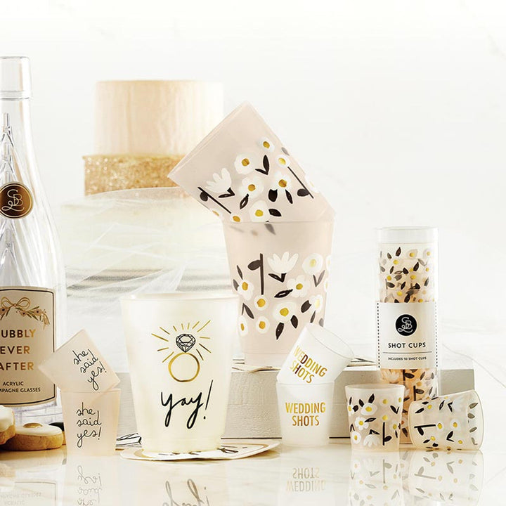Santa Barbara wedding shot cups with floral pattern and champagne glasses on white surface