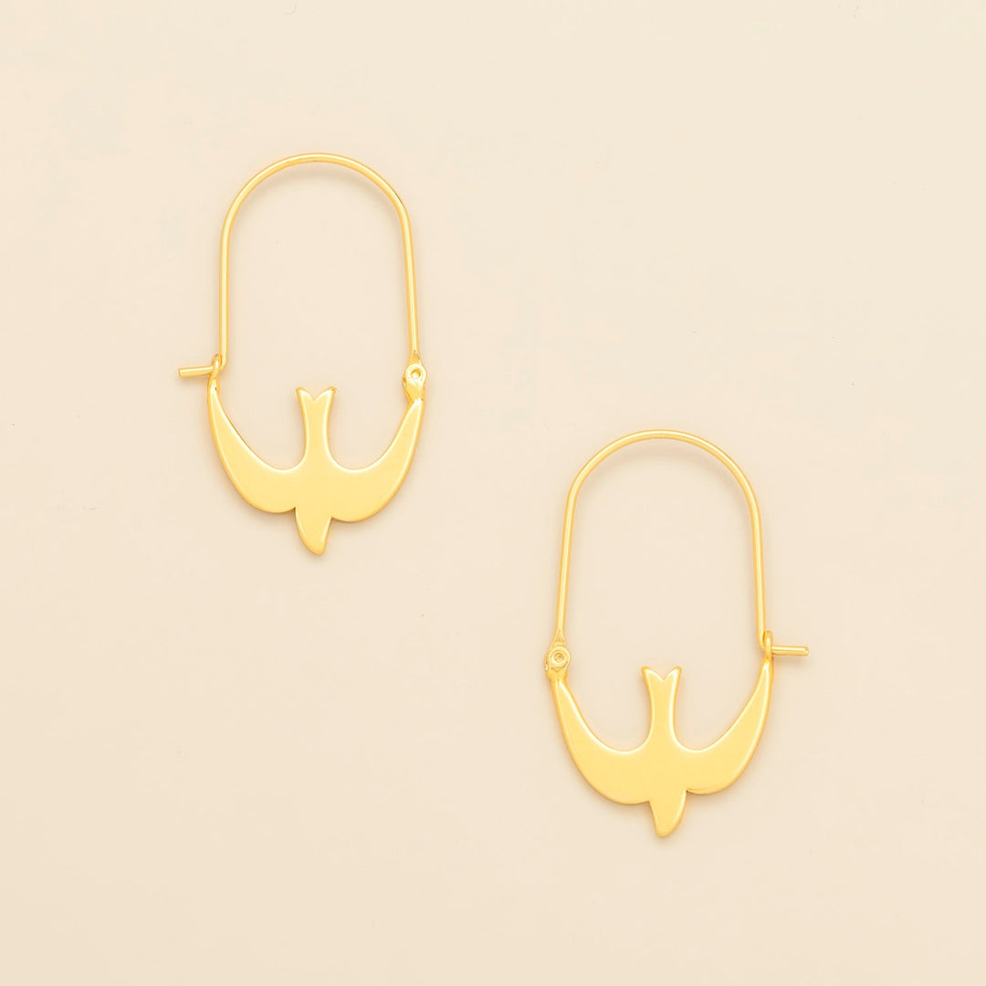 Scout Refined Icon Earrings in gold swallow hoop design, pair shown on neutral background