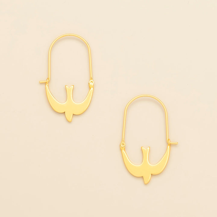 Scout Refined Icon Earrings in gold swallow hoop design, pair shown on neutral background