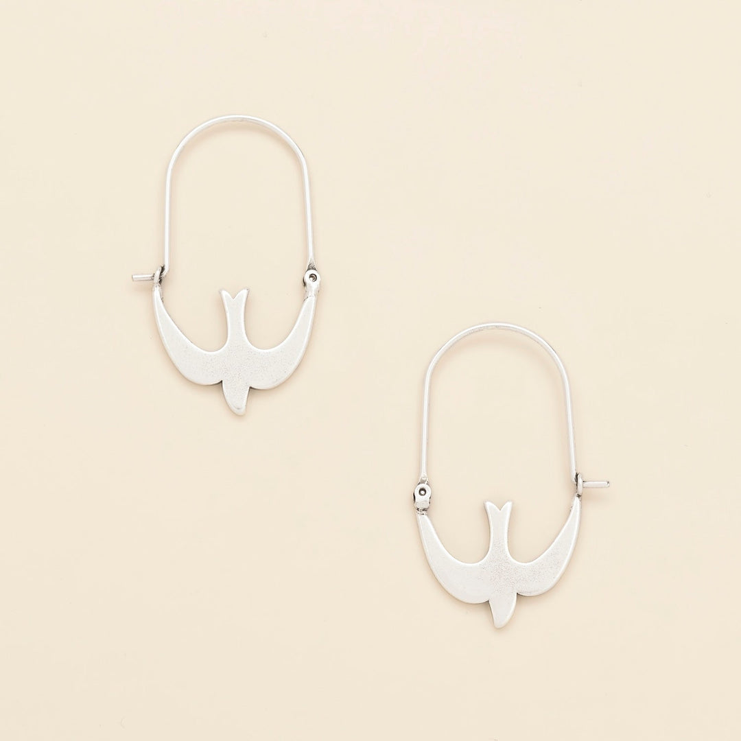 Scout Refined Icon Earrings in silver swallow hoop design, pair shown on neutral background
