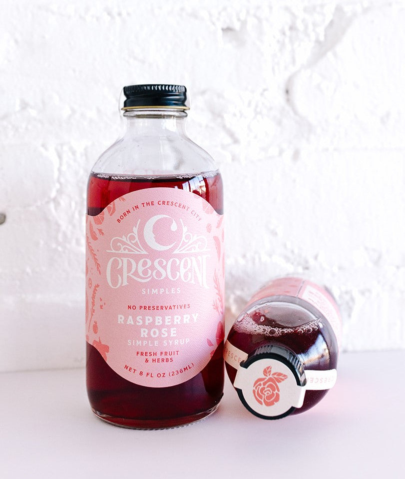 Crescent Simples Raspberry Rose simple syrup bottle with dark red liquid and pink label