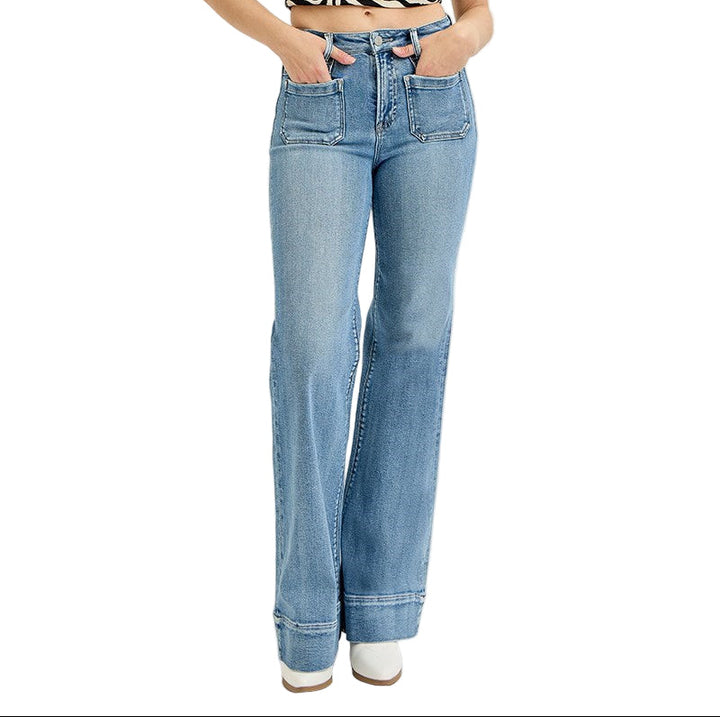 Woman wearing high rise wide leg flare jeans in medium blue denim wash