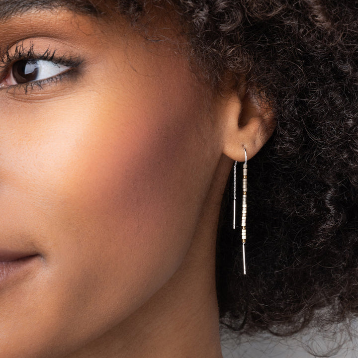 Model wearing Scout Chromacolor Miyuki gold and silver thread earring