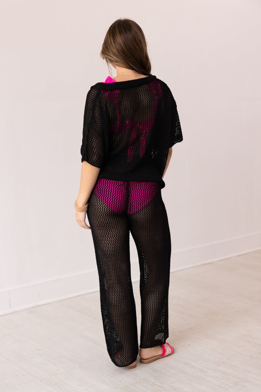 Black crochet cover-up shirt and pants set shown from back on model