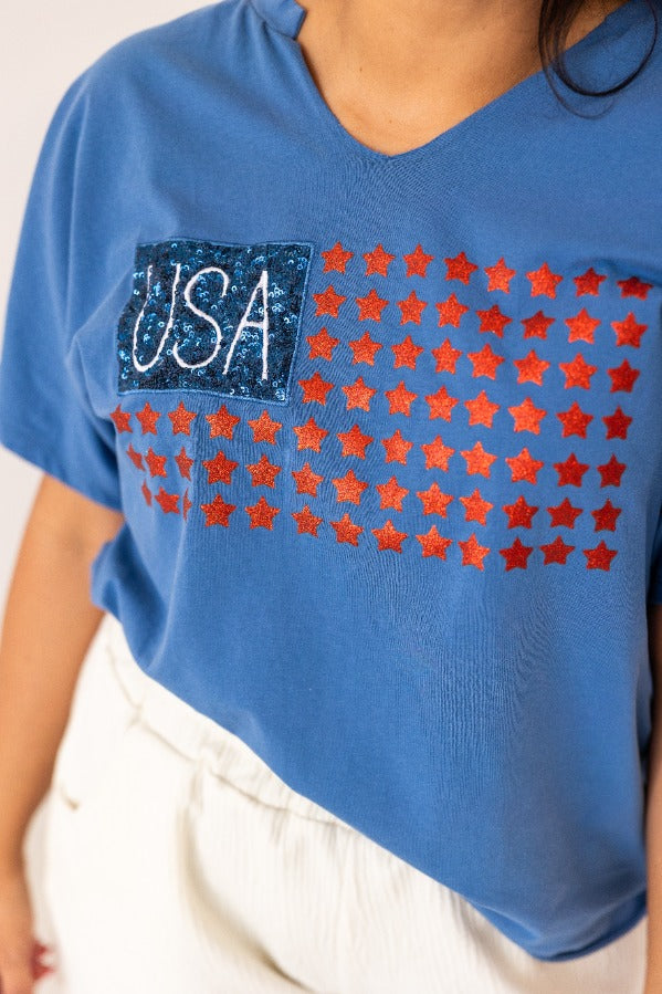 Blue v-neck t-shirt with USA flag design made of glitter stars