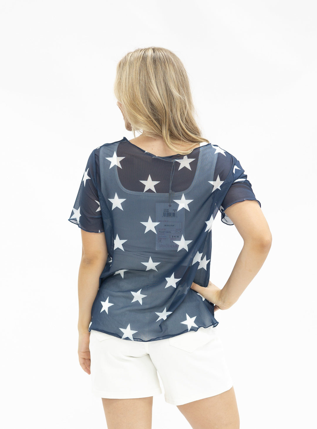 Navy blue mesh short-sleeve top with white star pattern, shown from back view