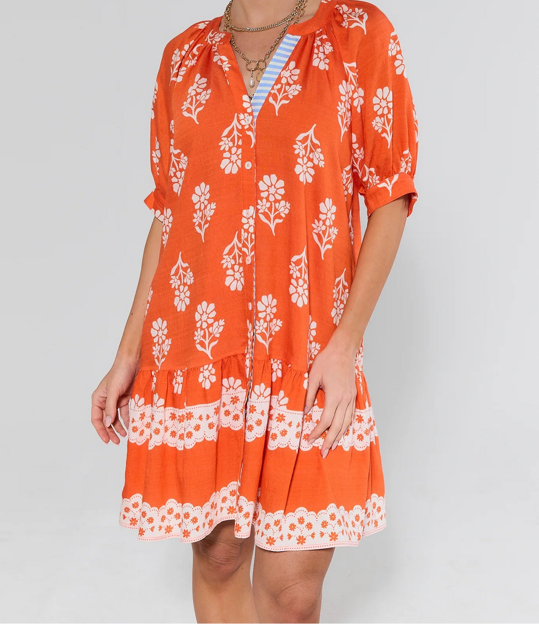 Orange floral print button-up dress with short sleeves and tiered hem