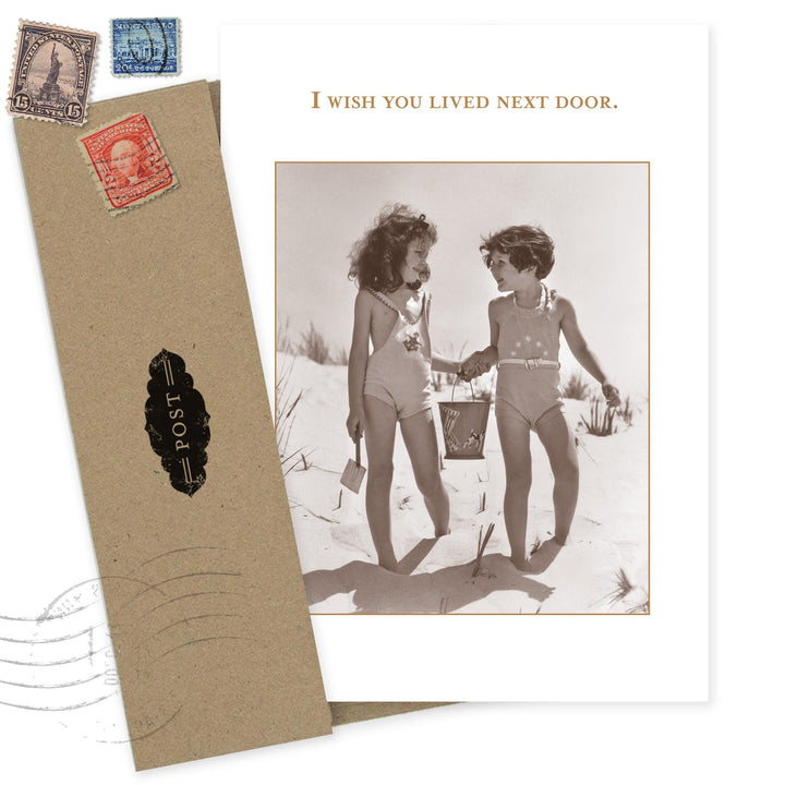 Next Door greeting card featuring vintage photo of two children on beach with postage stamps