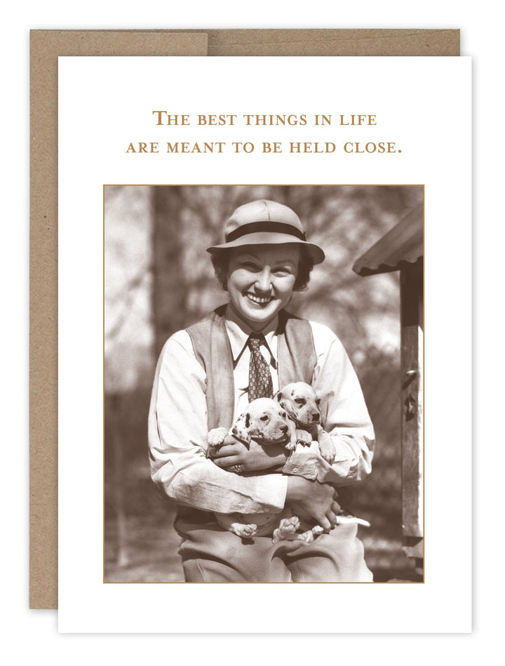 Birthday card featuring vintage photo of man with puppies, text reads best things held close