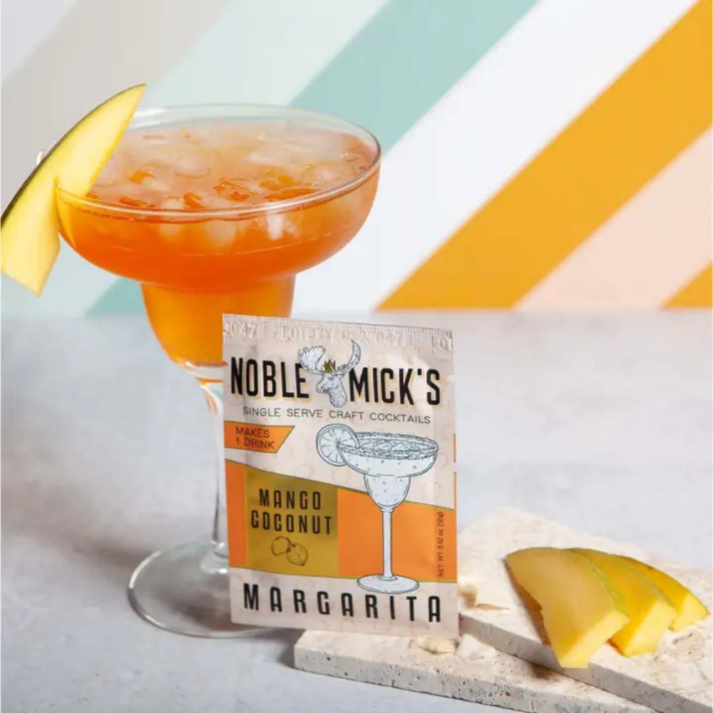 Noble Mick's Mango Coconut Margarita single serve craft cocktail packet with styled drink
