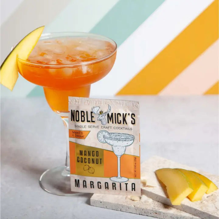 Noble Mick's Mango Coconut Margarita single serve craft cocktail packet with styled drink