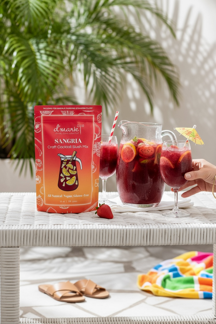 D'Marie Sangria Craft Cocktail Slush Mix package with prepared drinks and tropical setting