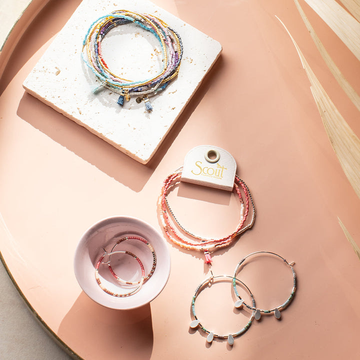 Scout Chromacolor Miyuki jewelry collection featuring colorful bracelets and large hoop earrings