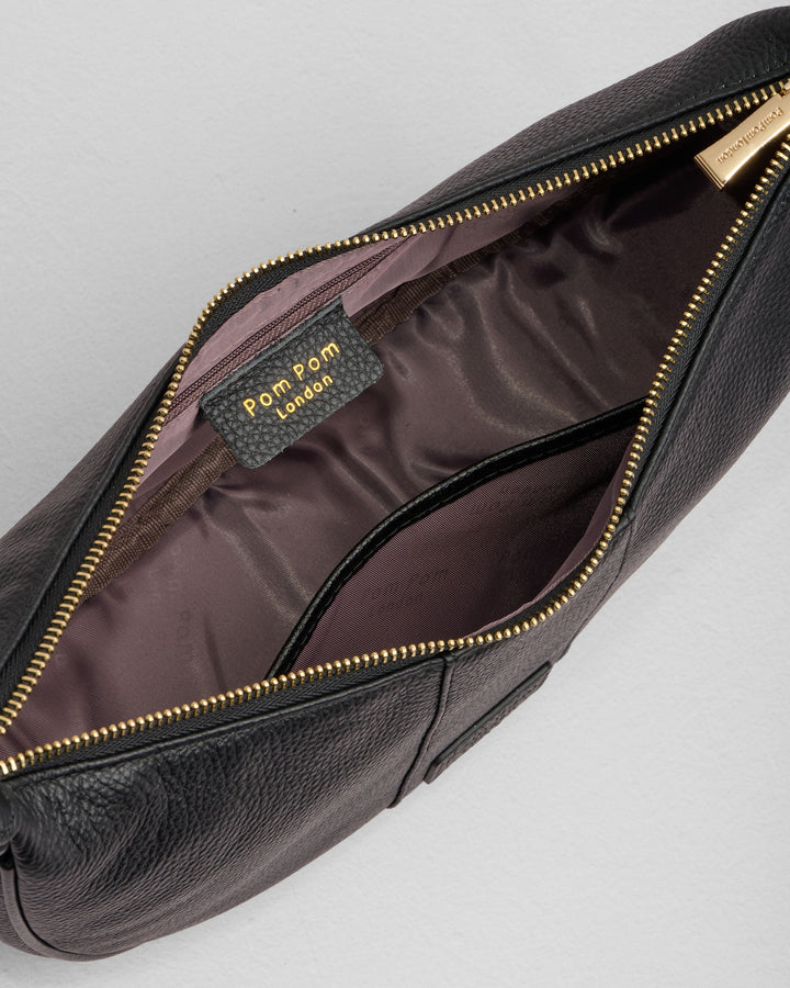 Black Pom Pom London Sutton Sling Bag opened showing interior compartments and gold zipper